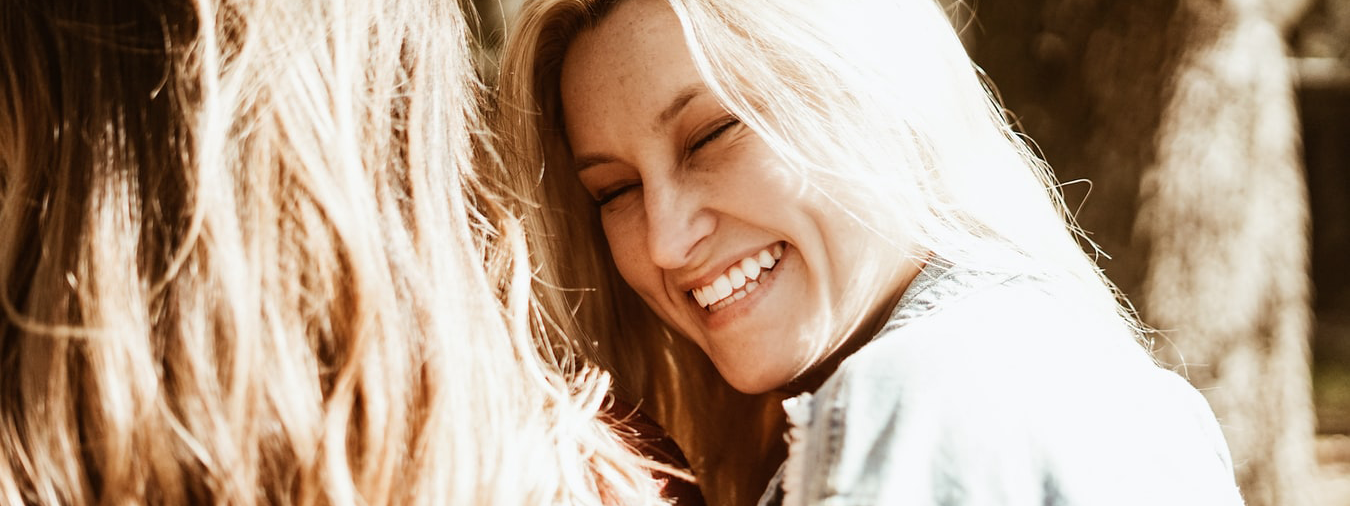 Woman smiling at another woman