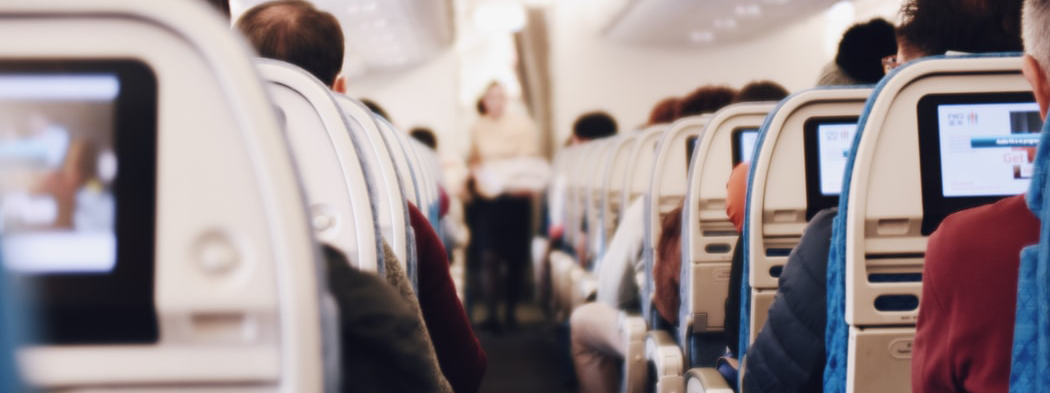 Airplane seats with rows of people