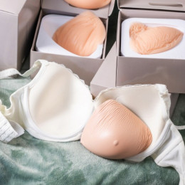 Silicone breast forms and a white post-mastectomy bra displayed for Binson's mastectomy clearance sale