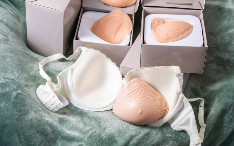 Silicone breast forms and a white post-mastectomy bra displayed for Binson's mastectomy clearance sale
