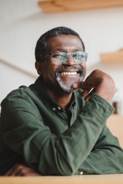 Man sitting at a table smiling