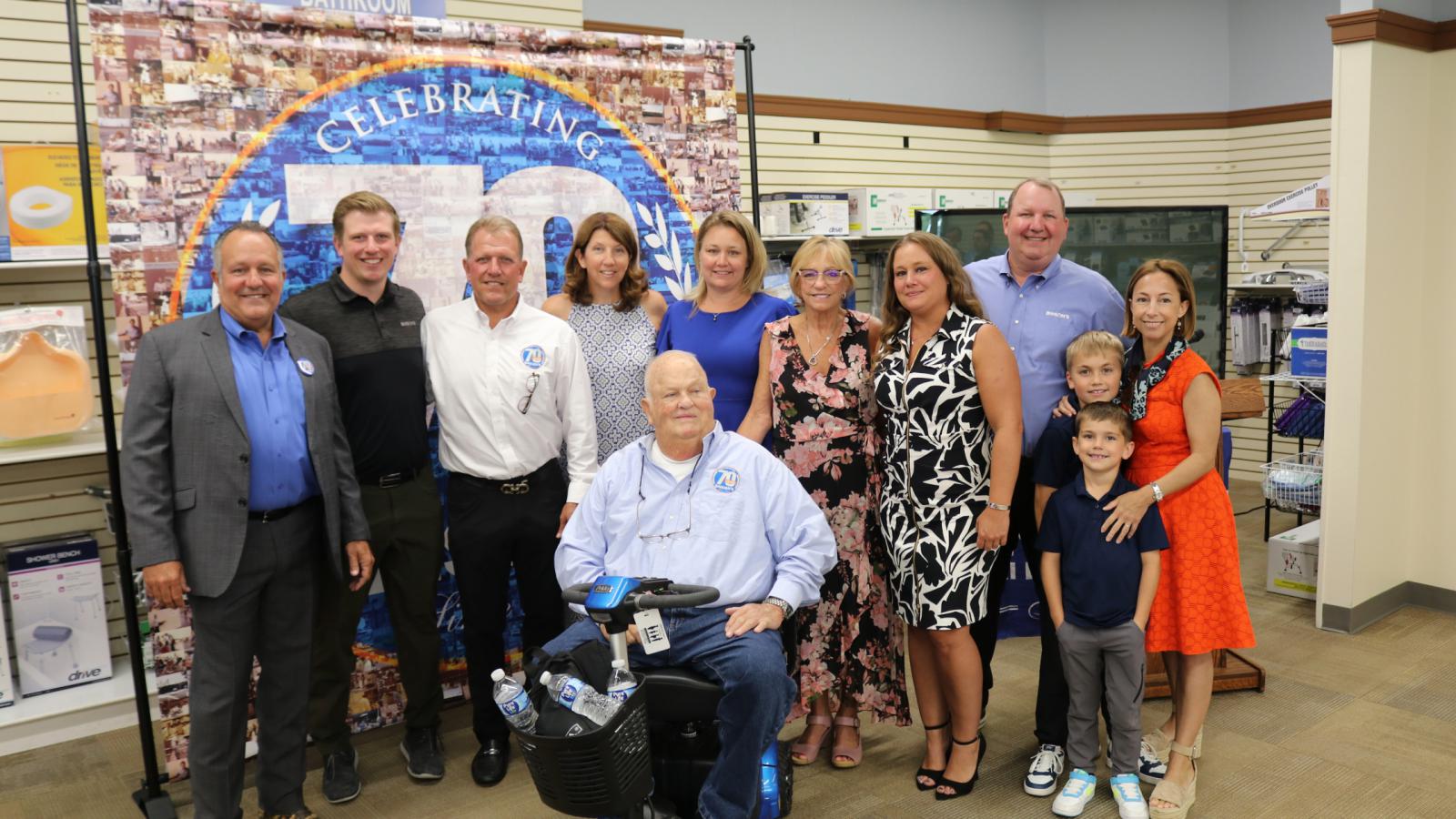 BinsonÂ family in front of 'Celebrating 70 Years