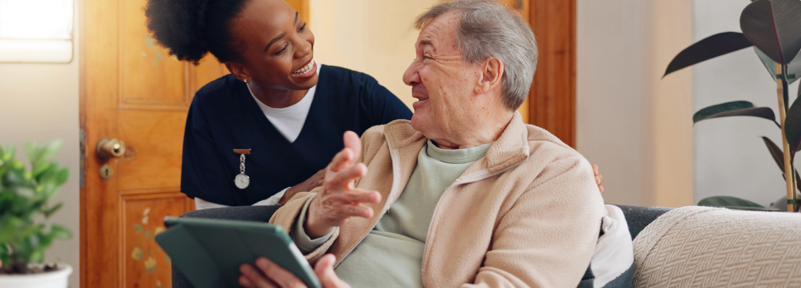 Nurse in home, with a patient sitting in a wheelchair