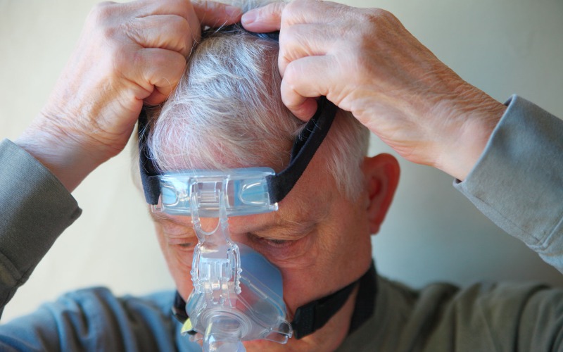 Person putting on a cpap mask