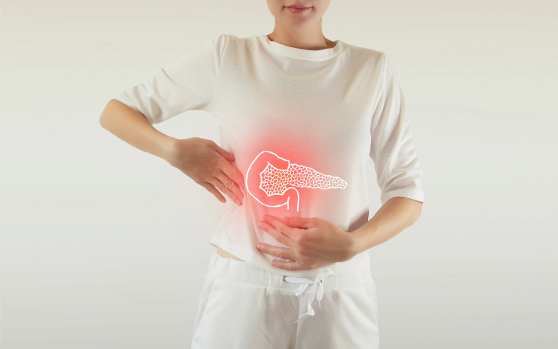 Image of a person holding the area of their body where the pancreas is