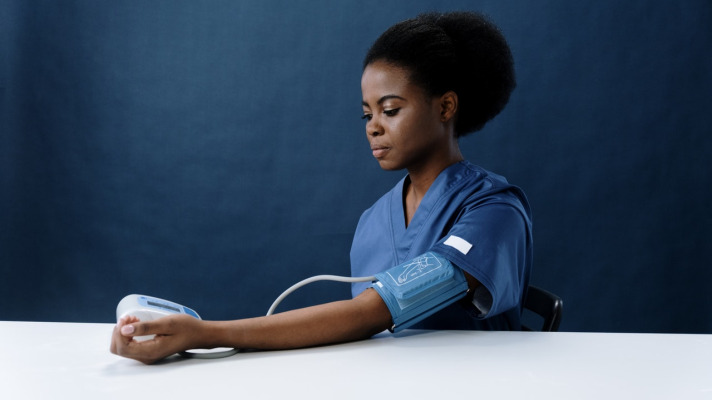 Woman checking blood pressure with digital blood pressure monitor Photo by cottonbro from Pexels