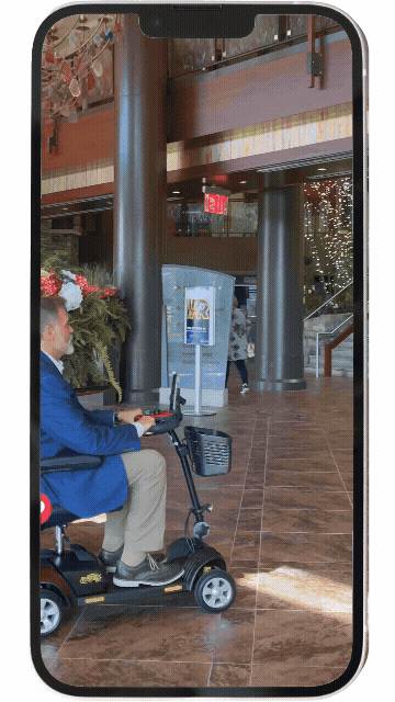 Person riding a mobility scooter clip