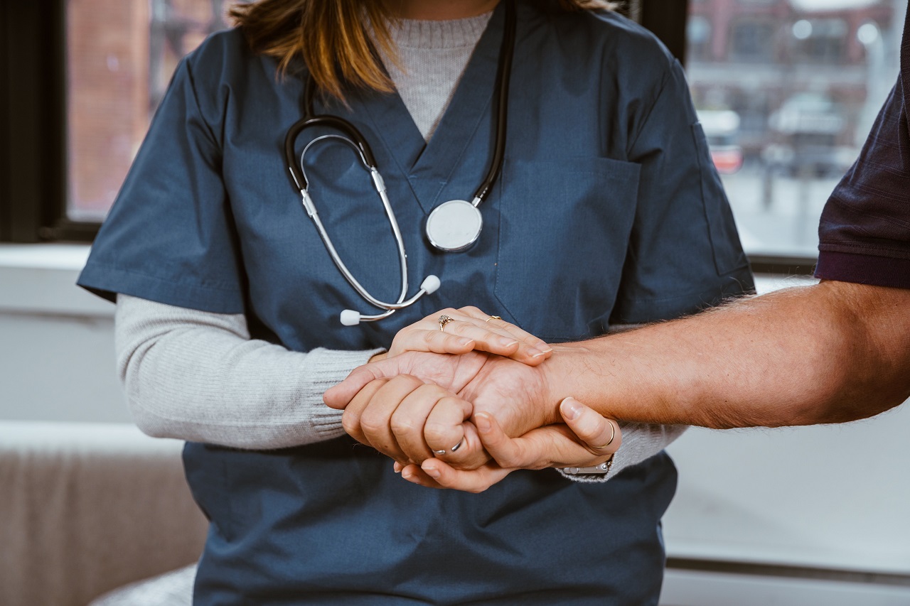 Nurse shaking hand of patient